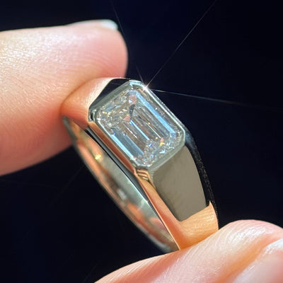 Model holding a 14k Yellow Gold 1.5ct F VVS Emerald Cut Lab Diamond Custom Signet Ring, Size 6.5