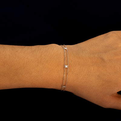 A model wearing a white gold double chain 8 pointed star bracelet