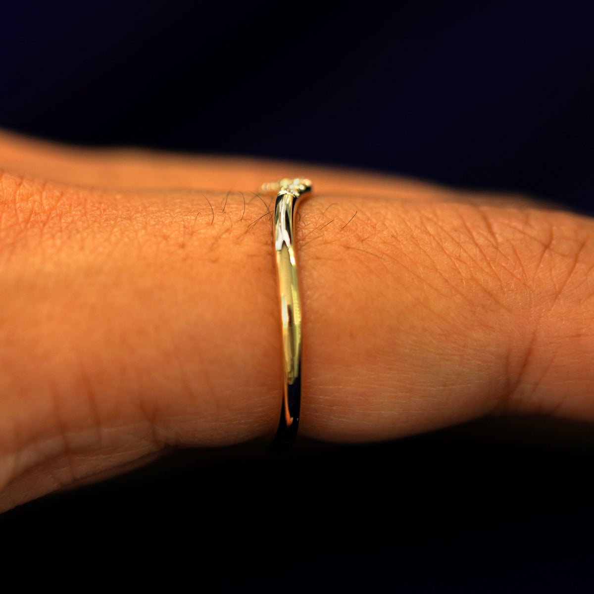 Side view of a Diamond Chevron Band on a model's finger to show details