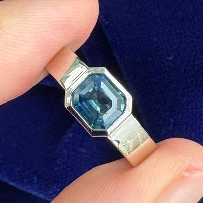 14k Champagne Gold with Bezel-sideways-set 1.11ct Emerald-cut Montana Teal Sapphire on 4mm Industrial Mirror Band Custom Ring, size 4.75
