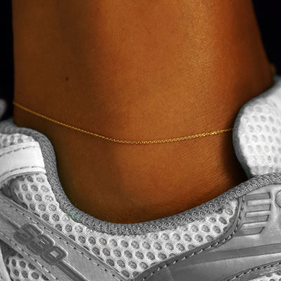 A model's ankle wearing a yellow gold Cable Anklet