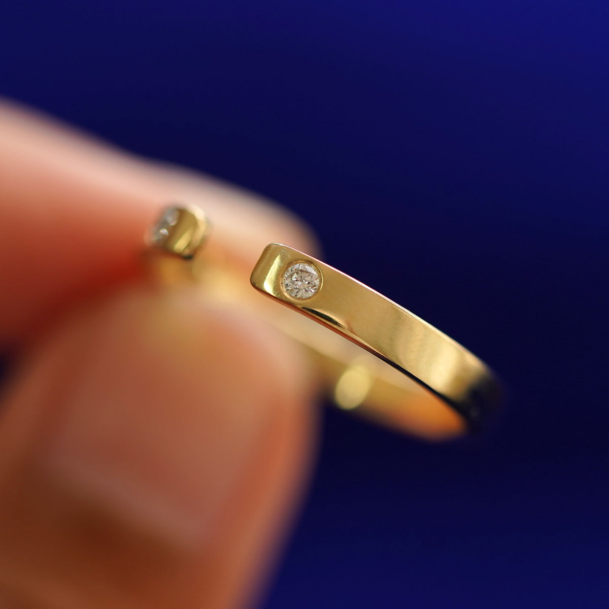 A model holding a Open Industrial Band tilted to show the side of the ring
