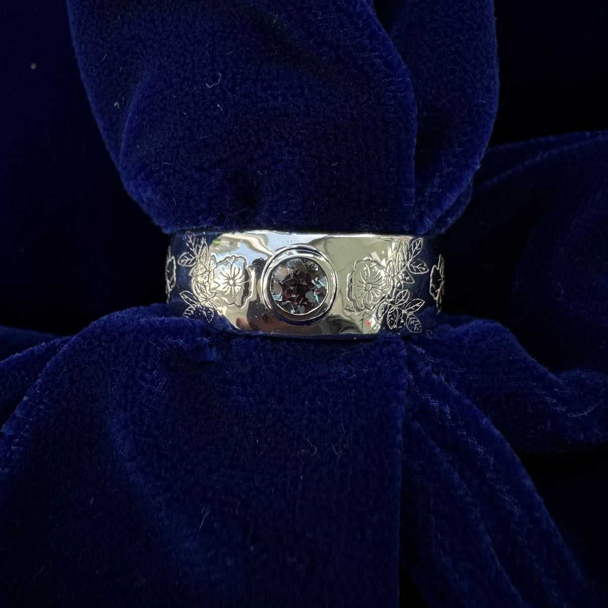 14k White Gold Bezel Set 4mm Round Alexandrite on 8-6mm Curvy Tapered Mixed Flowers Engraved Custom Band