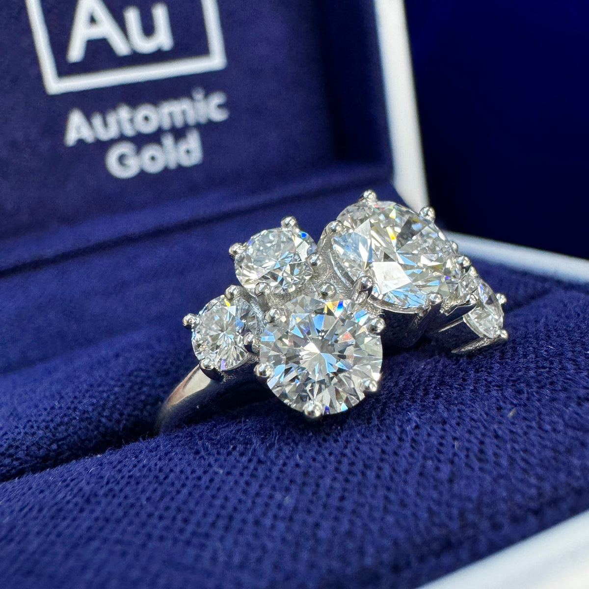 Lab diamond cluster ring in a blue ring box