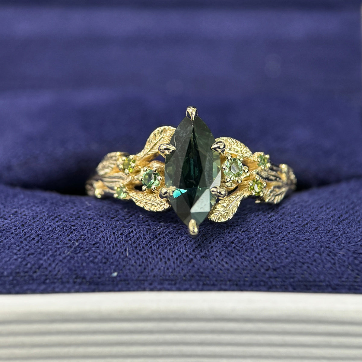 14k Yellow Gold & 6-claw-prongs-petal High-set 1.46ct 11x5.2mm Marquise Sapphire & Cluster of 6 Green Sapphires on Custom Leaves Tapered Band