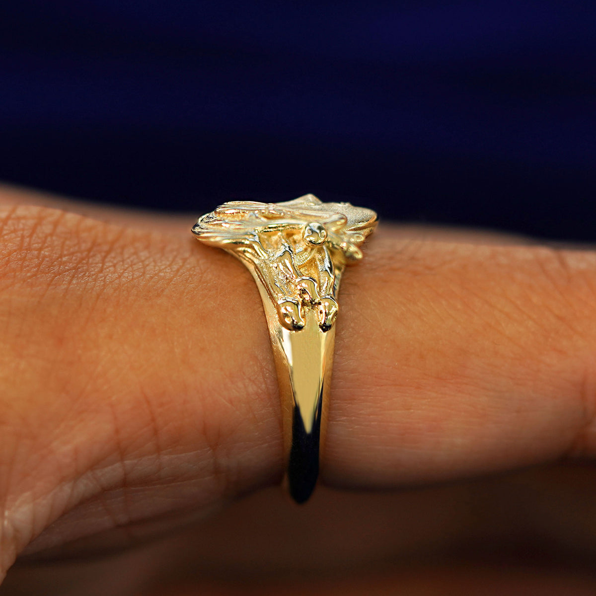 Side view of a Medusa Ring on a model's finger to show the details of her snake hair
