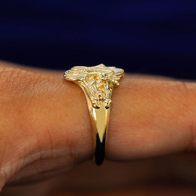 Side view of a Medusa Ring on a model's finger to show the details of her snake hair