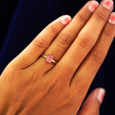 A model wearing a solid yellow gold Kepeh Ring on their ring finger