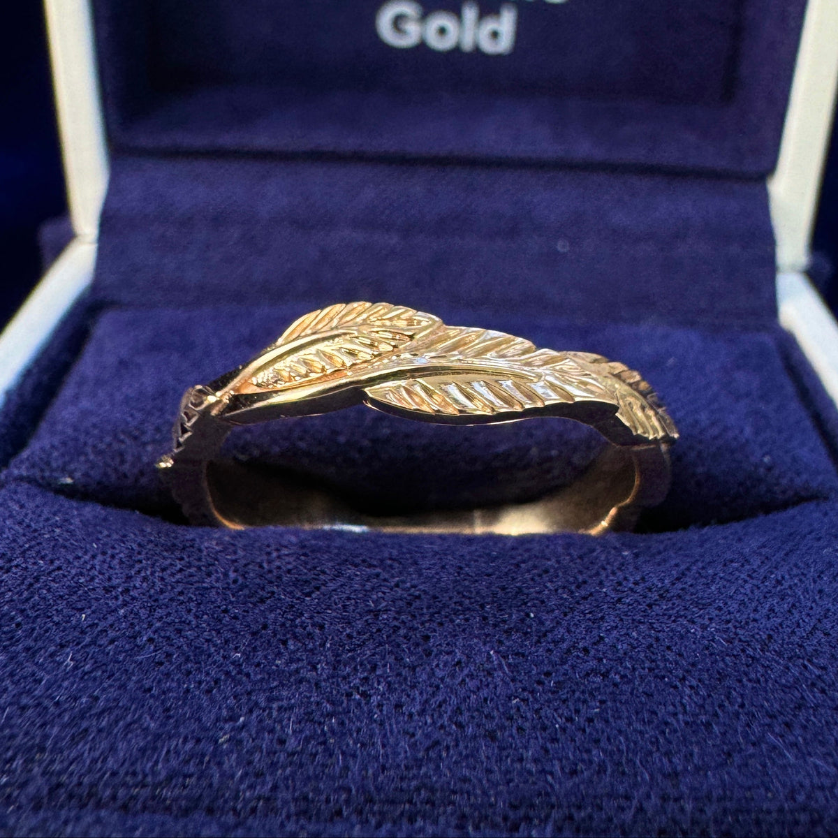 14k Peach Gold Custom Thick Leaves Band in a blue ring box