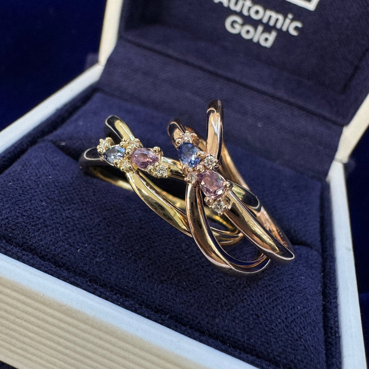 14k Yellow Gold Bezel-set Custom-cut Pear Ceylon Blue Lab Sapphire & Pear Purple Lab Sapphire w/ 4pc Round Lab Diamonds on Thin Twisting Band Custom Ring, size 8.5 & 14k Rose Gold Bezel-set Custom-cut Pear Ceylon Blue Lab Sapphire & Pear Purple Lab Sapphire w/ 4pc Round Lab Diamonds on Thin Twisting Band Custom Ring