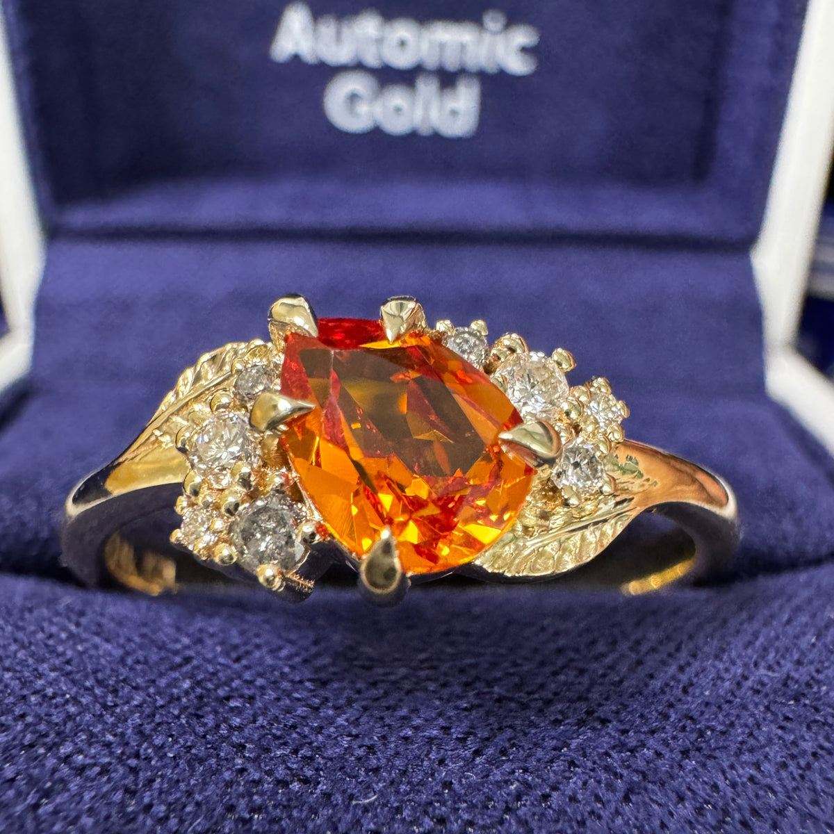 14k Yellow Gold & 7x5mm Pear Orange Lab Sapphire with a cluster of White and Salt-and-Pepper Diamonds on Leaves Band Custom Ring