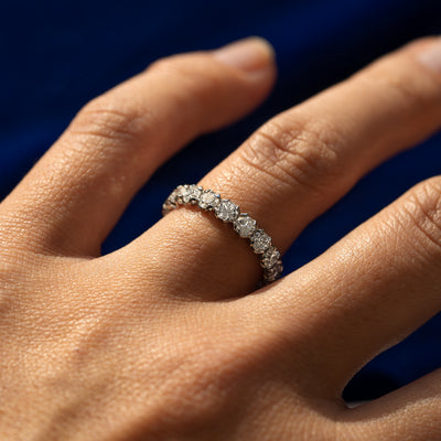 Side view of a Petal Set Diamond Eternity Band on a model's finger