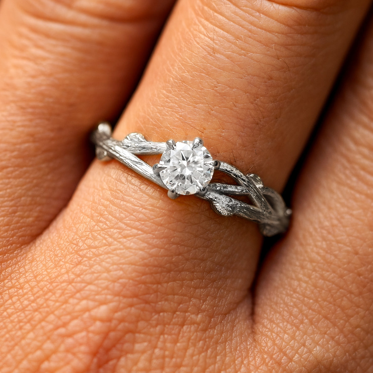 Close up view of a model's fingers wearing a platinum lab diamond Branches Ring