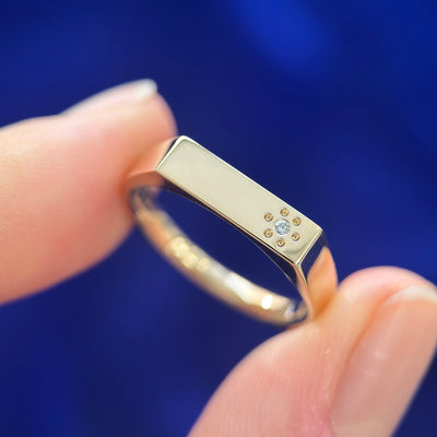 14k yellow gold rectangular signet custom ring with small diamond and 6 dots around off set on the top, engraved inside “love love love”, size 6.5