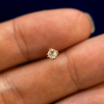 A model holding a rose cut diamond flatback piercing