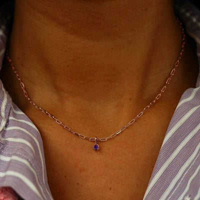 Close up view of a model's neck wearing a rose gold Amethyst Charm on a Butch Chain