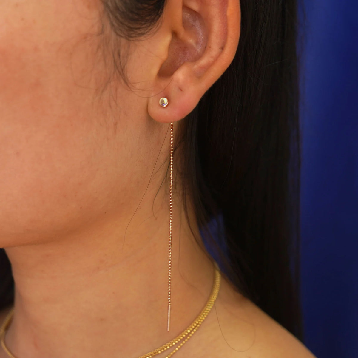 Close up view of a model's ear wearing a rose gold  Circle Threader