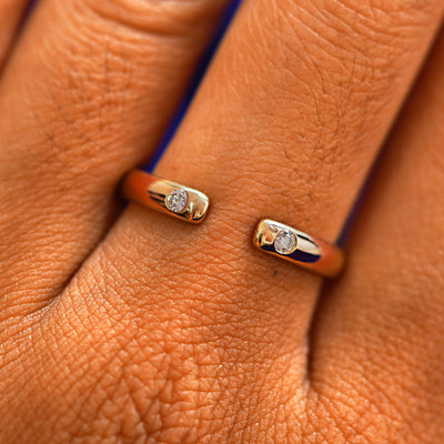 Close up view of a model's fingers wearing a 14k rose gold Open Curvy Band