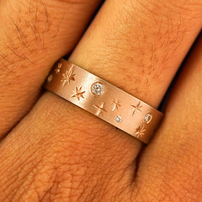 Close up view of a model's fingers wearing a 14k rose gold Stars and Diamonds Band