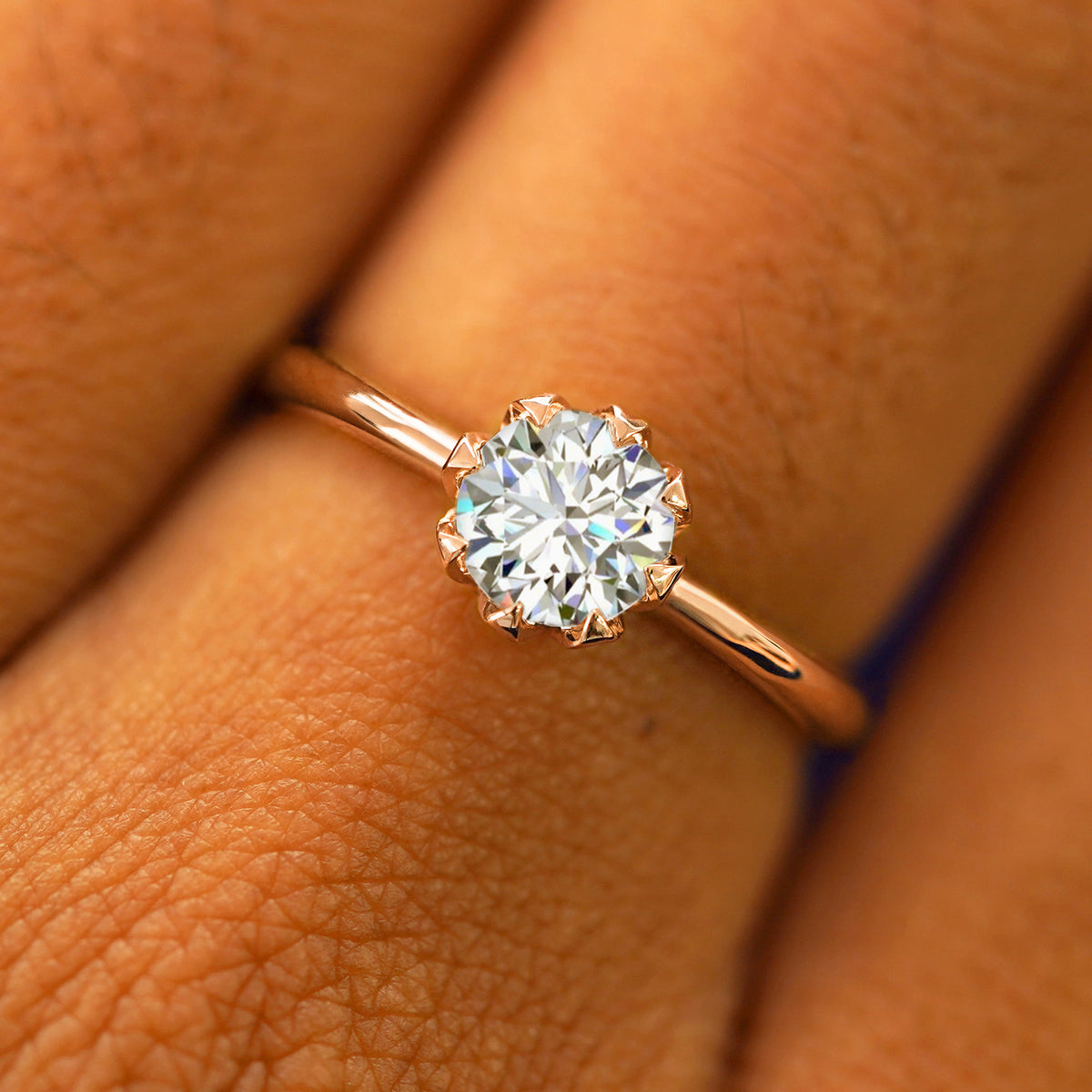 Close up view of a model's hand wearing a solid rose gold Lab Diamond Petal Ring