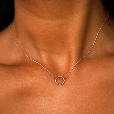 Close up view of a model's neck wearing a solid 14k rose gold Lockless Cable Necklace