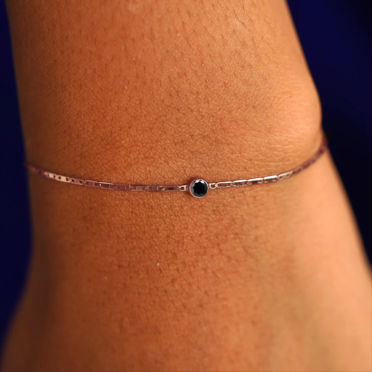 A model's wrist wearing a 14 karat rose gold Onyx Bracelet