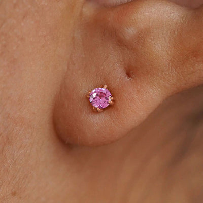 Close up view of a model's ear wearing a 14k rose gold Onyx Earring