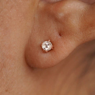 A model's ear wearing a 14k solid rose gold Rose Cut Diamond Earring