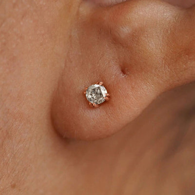 A model's ear wearing a 14k rose gold Salt and Pepper Diamond Earring