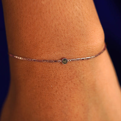 A model's wrist wearing a 14 karat rose gold Smoky Quartz Bracelet
