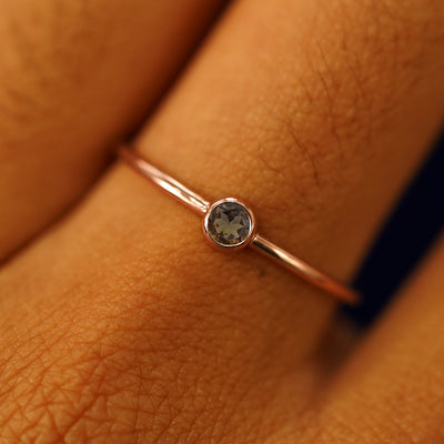 Close up view of a model's fingers wearing a 14k rose gold Smoky Quartz Ring