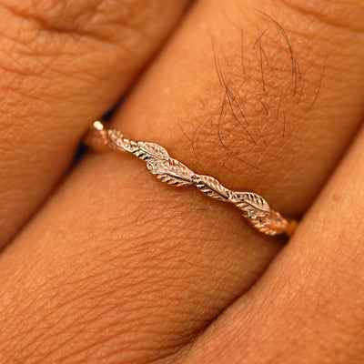 Close up view of a model's fingers wearing a 14k rose gold Thin Leaves Band