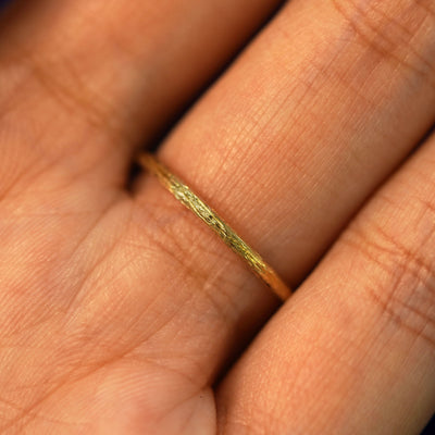Close up view of a model's palm showing how the band sits on the inside of a hand