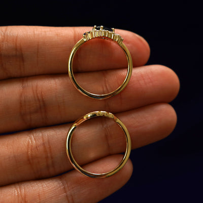 A yellow gold Alexandrite Cluster Ring and it's custom made band in a model's hand showing the thickness of the bands