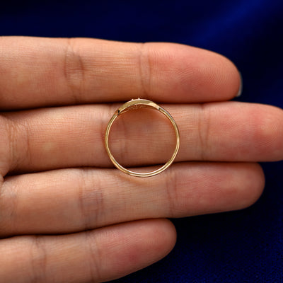 A yellow gold Gemstone Evil Eye Ring in a model's hand showing the thickness of the band