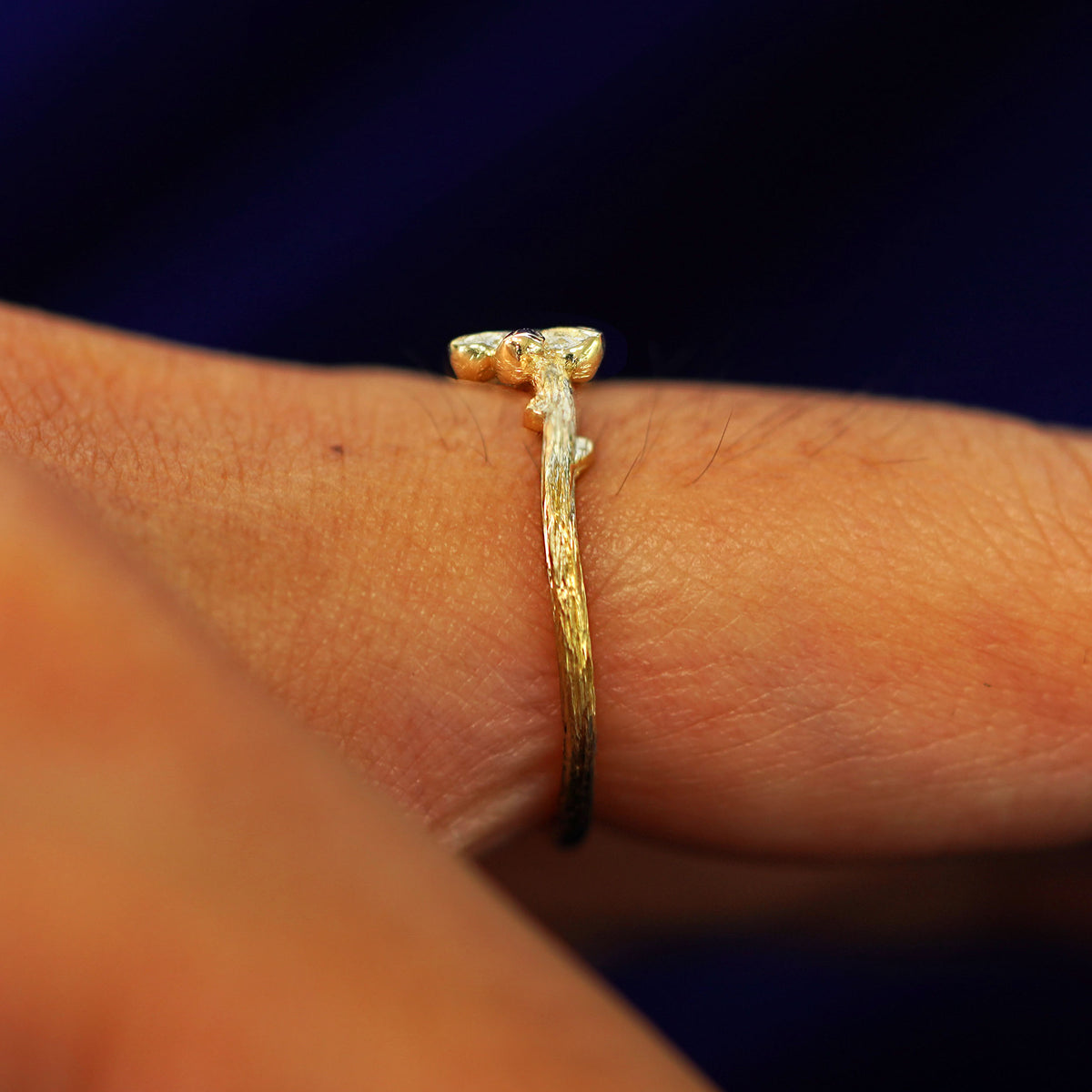 Side view of a Sakura Ring on a model's finger