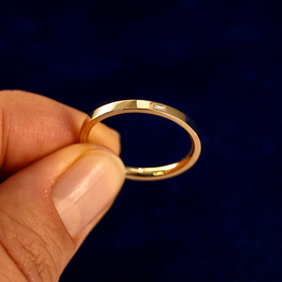 A model holding a Flush Set Baguette Diamond Ring tilted to show the details of the ring