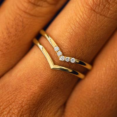A model's hand wearing a Chevron Band and a Diamond Chevron Band stacked