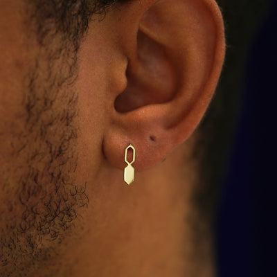 A model's ear wearing a 14k yellow gold Tanlah Earring vertically