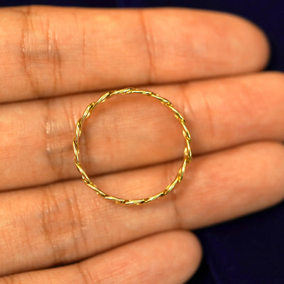 A solid 14k Curb Chain Ring resting on a model's fingertips to show the thickness of the band