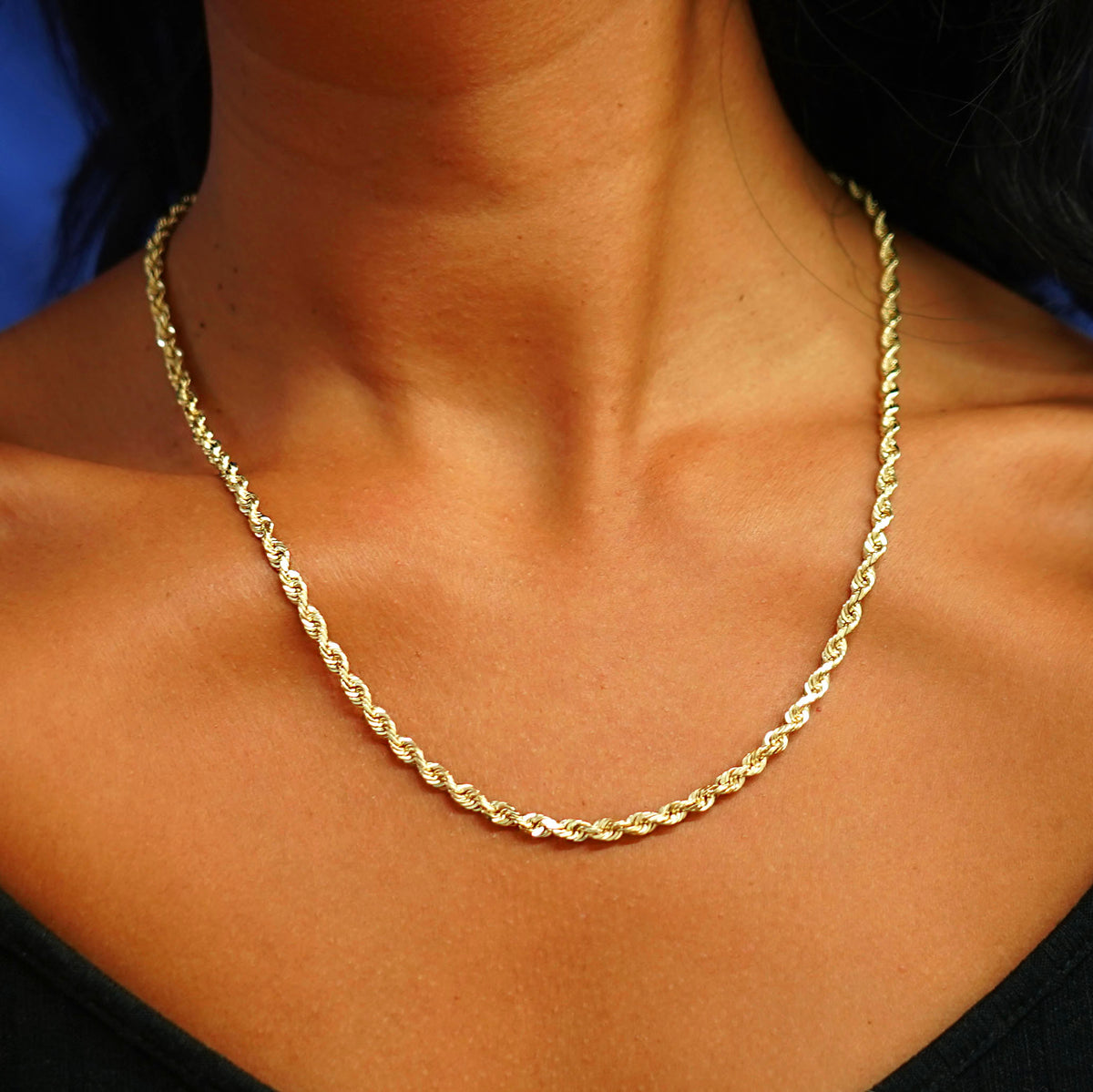 A model's neck wearing a yellow gold Thick Rope Chain 