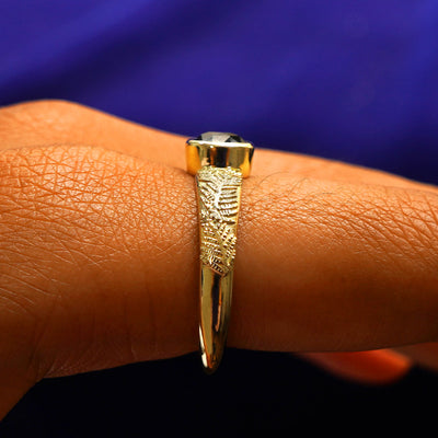Side view of a Dark Green Sapphire Pine Ring on a model's finger to show the hidden halo
