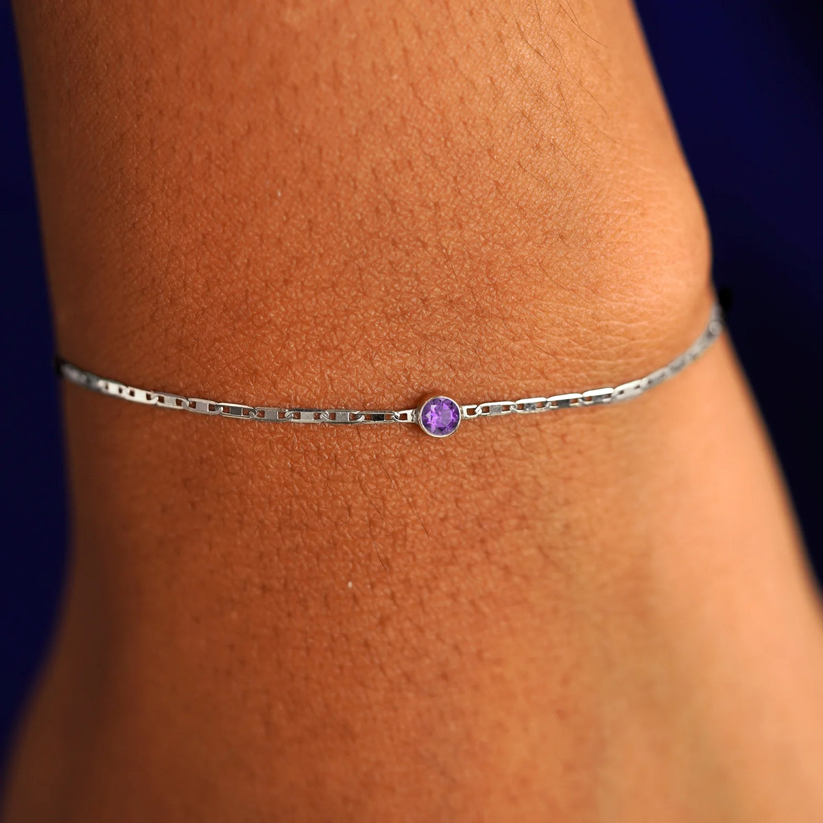 A model's wrist wearing a 14 karat white gold Amethyst Bracelet