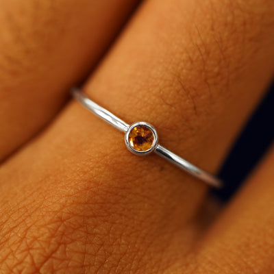 Close up view of a model's fingers wearing a 14k white gold Citrine Ring