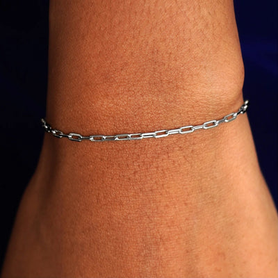 Close up view of a model's wrist wearing a solid white gold Butch Bracelet