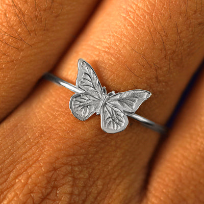 Close up view of a model's fingers wearing a white gold Butterfly Ring
