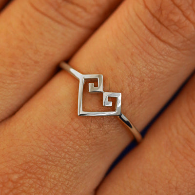 Close up view of a model's fingers wearing a 14k white gold Chere Heart Ring