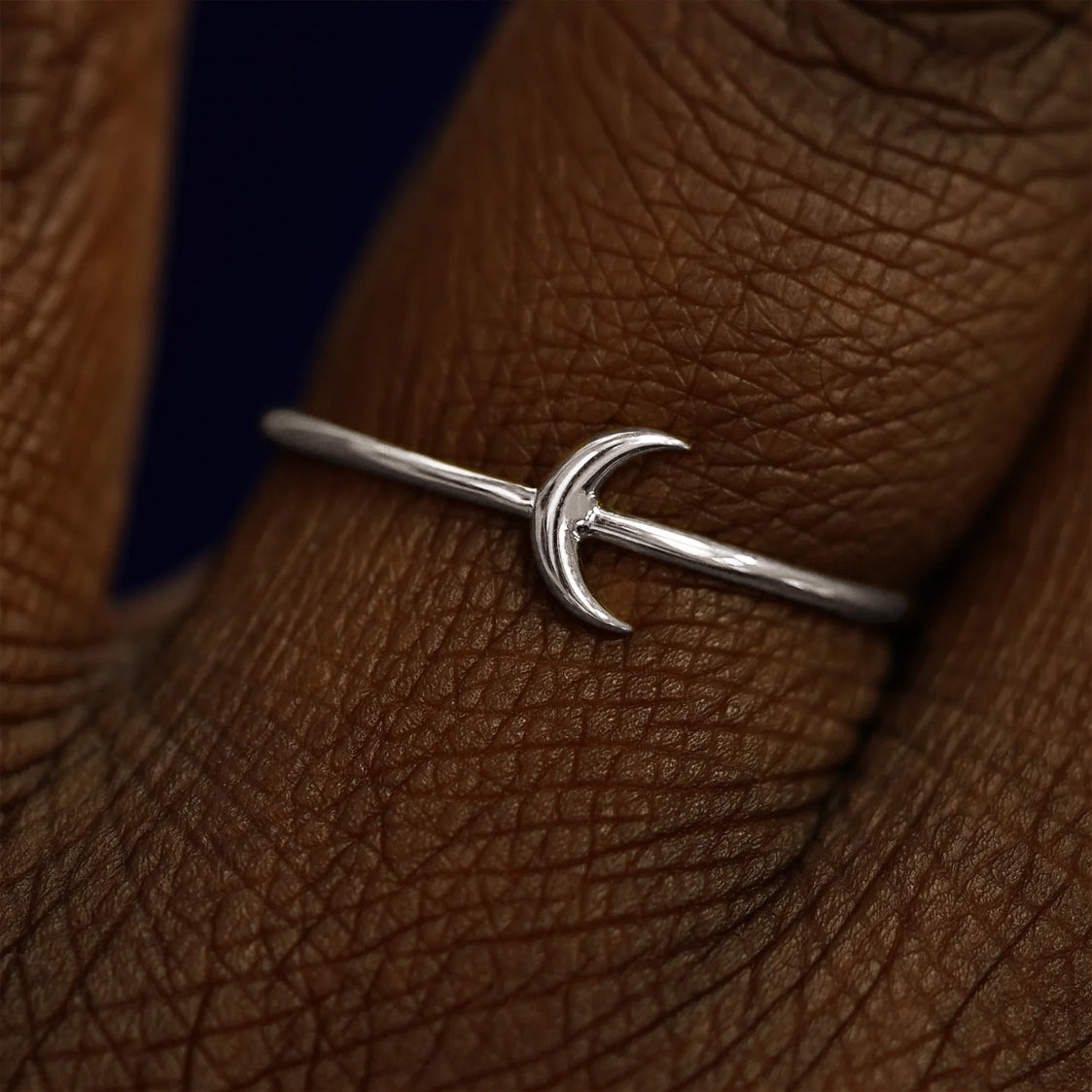 Close up view of a model's fingers wearing a 14k white gold Moon Ring
