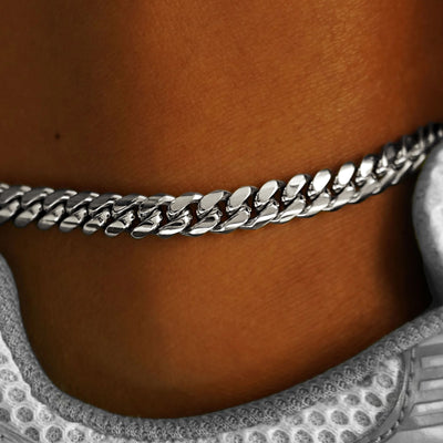 Close up view of a model's ankle wearing a white gold Miami Cuban Anklet