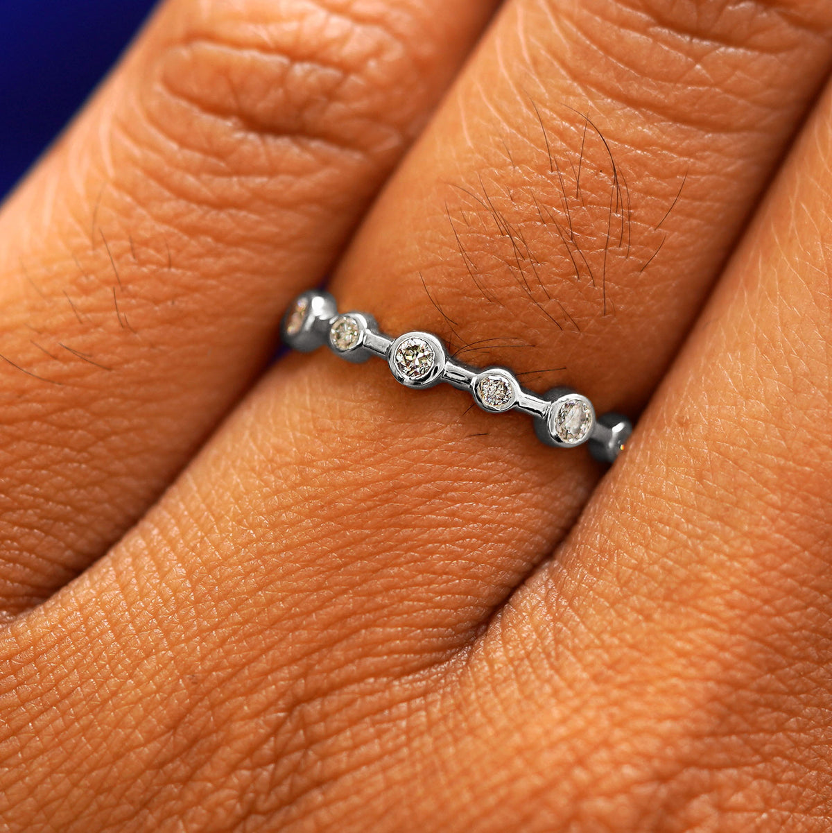 Close up view of a model's fingers wearing a 14k white gold Infinity Diamond Ring